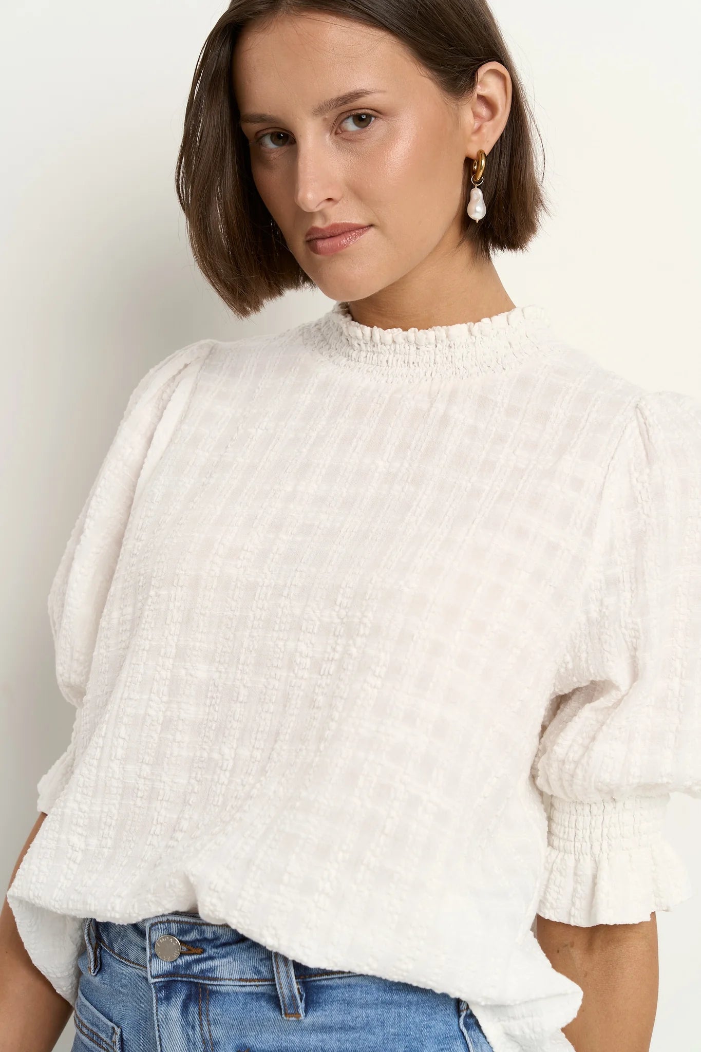 AMONG THE BRAVE INFLUENTIAL IVORY TEXTURE HIGH NECK TOP - THE VOGUE STORE