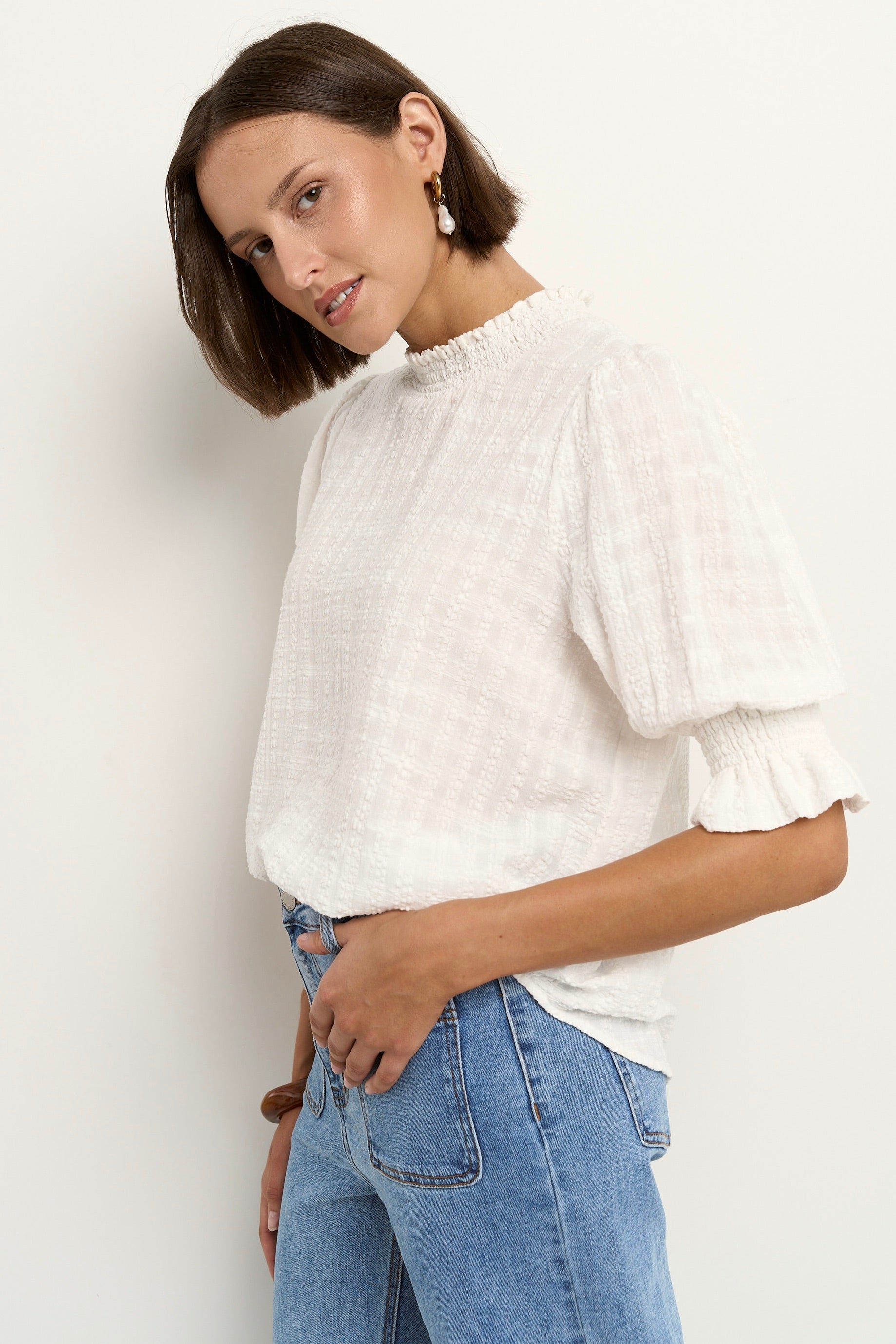 AMONG THE BRAVE INFLUENTIAL IVORY TEXTURE HIGH NECK TOP - THE VOGUE STORE